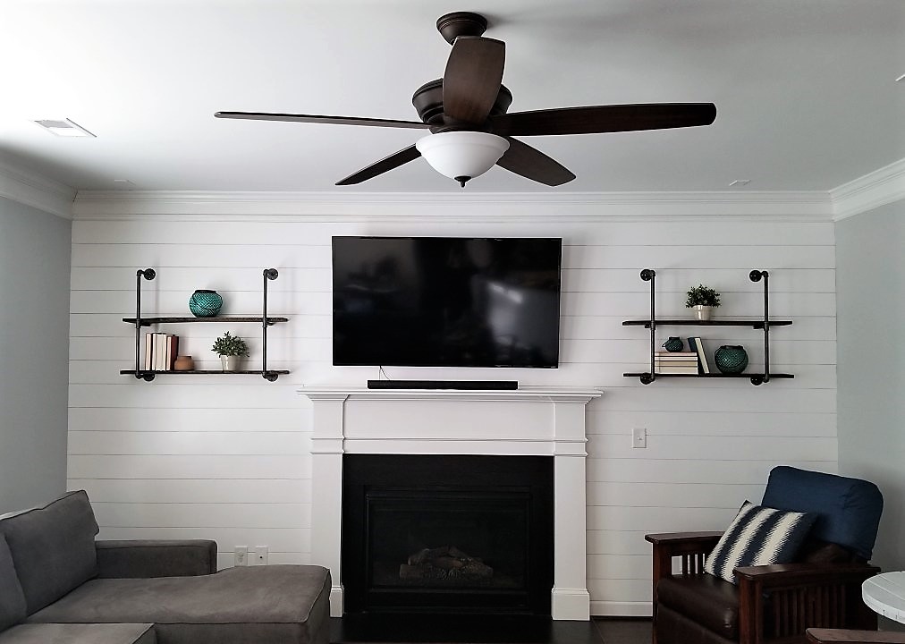 Living room with shiplap and industrial shelving