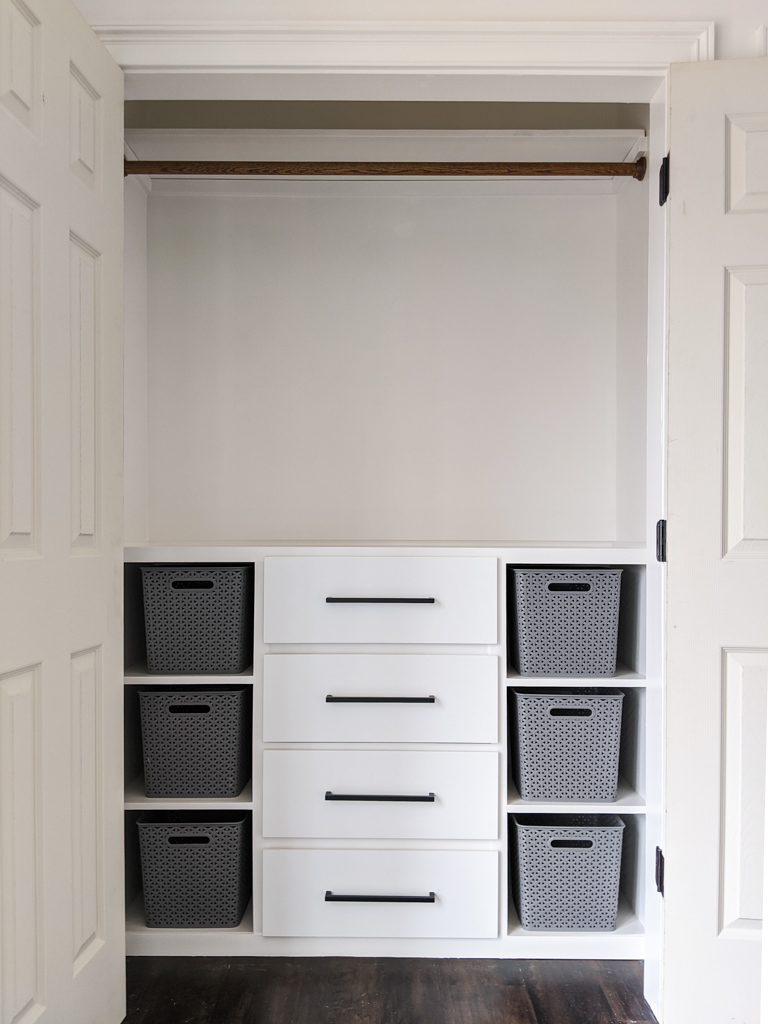 Small-custom-built-closet-with-dresser-and-bin-storage