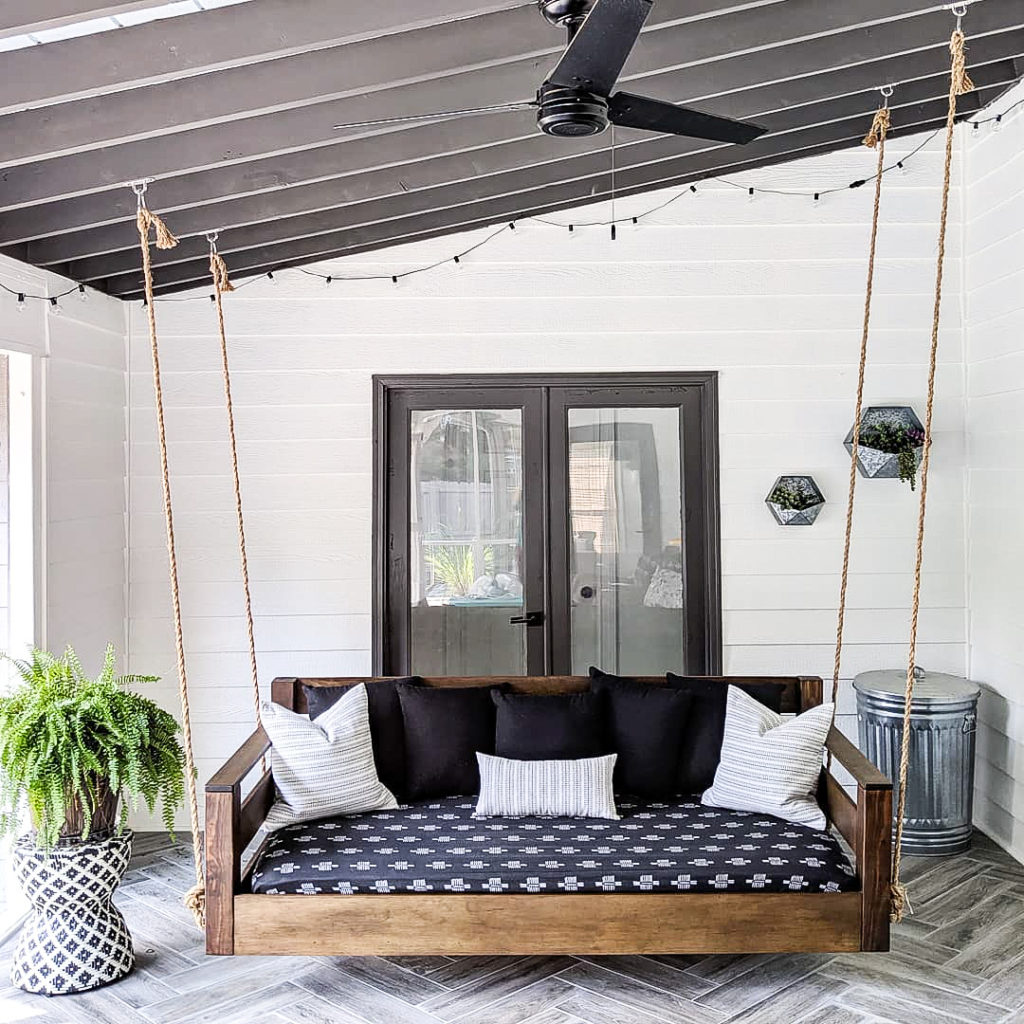Cozy-porch-with-bed-swing-and-string-lights