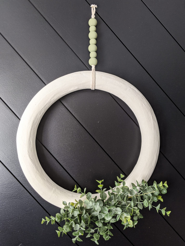 Mortar-wreath-with-faux-boxwood-stems-and-wooden-bead-hanger
