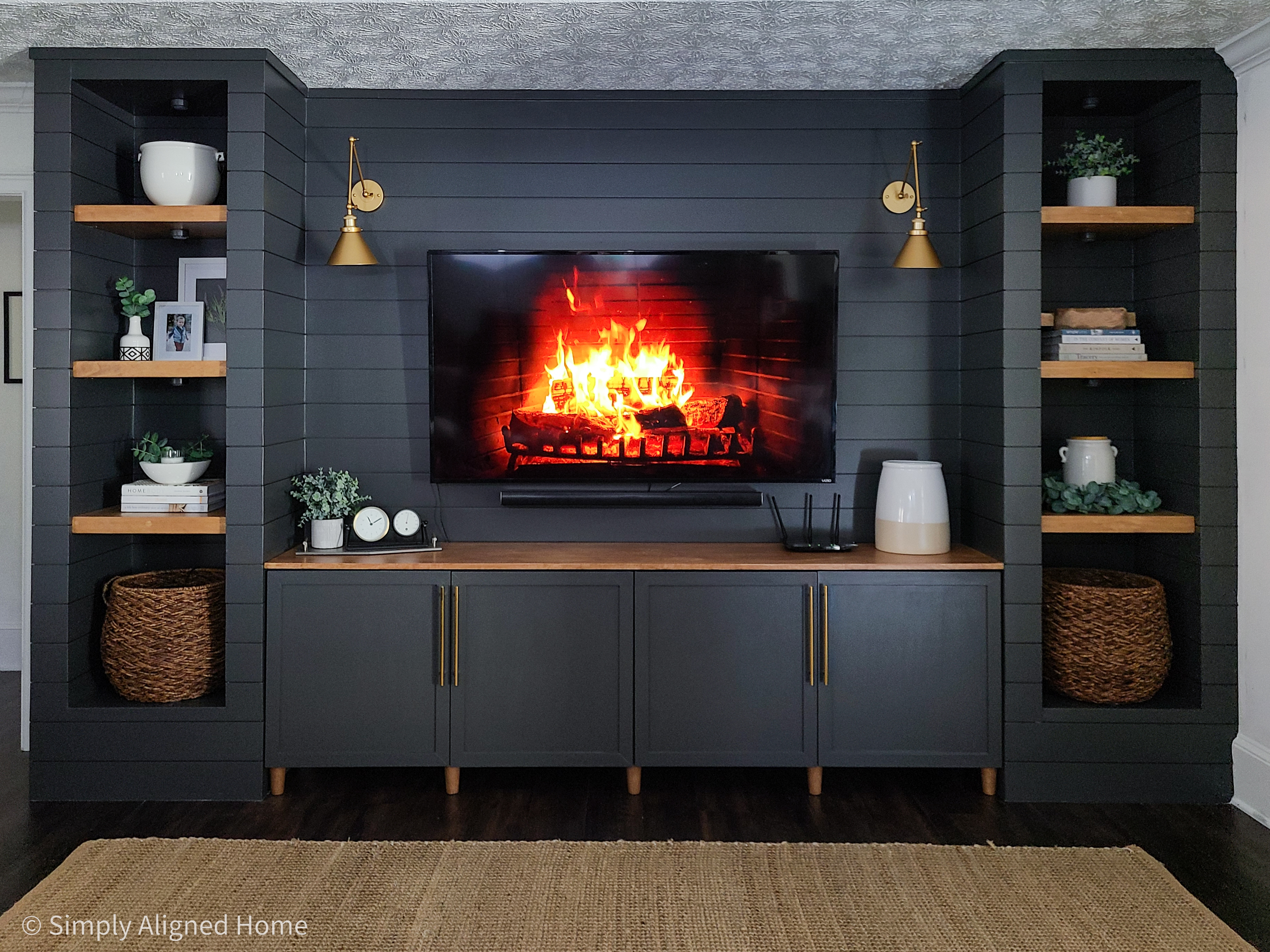 https://simplyalignedhome.com/wp-content/uploads/2021/01/Shiplap-built-in-unit-with-Iron-Ore-IKEA-BESTA-stained-wood-shelves.jpg