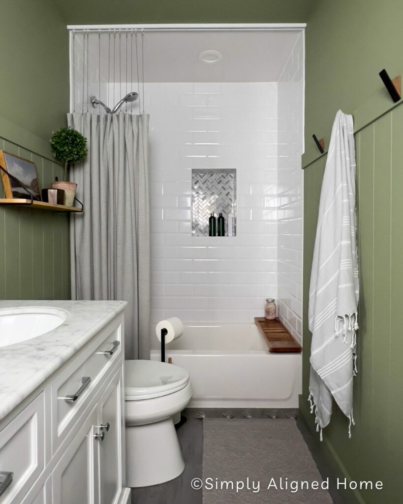 Vertical Shiplap in a bathroom painted green. 