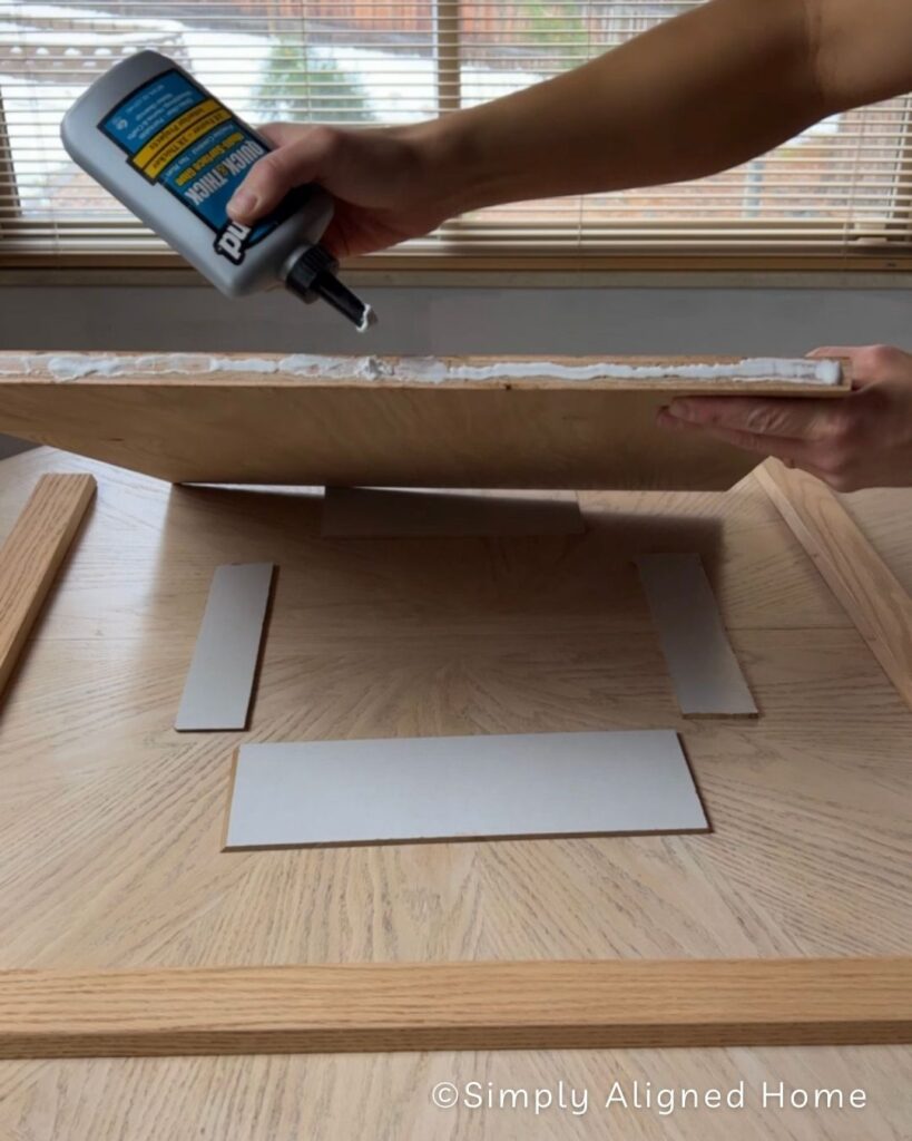 Adding wood glue to edges of plywood. 