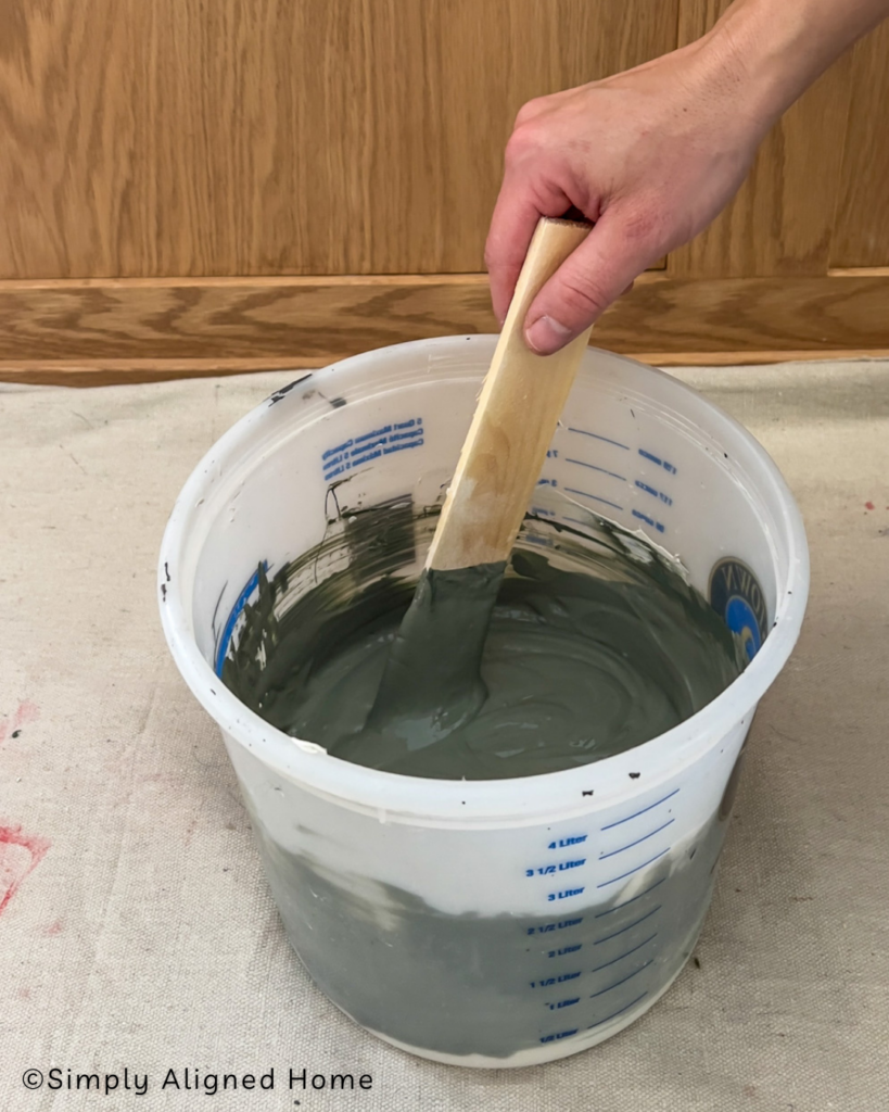Mixing the joint compound and paint together. 