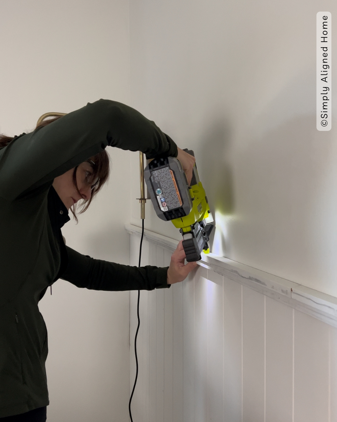 Using a brad nailer to install accent wall trim. 