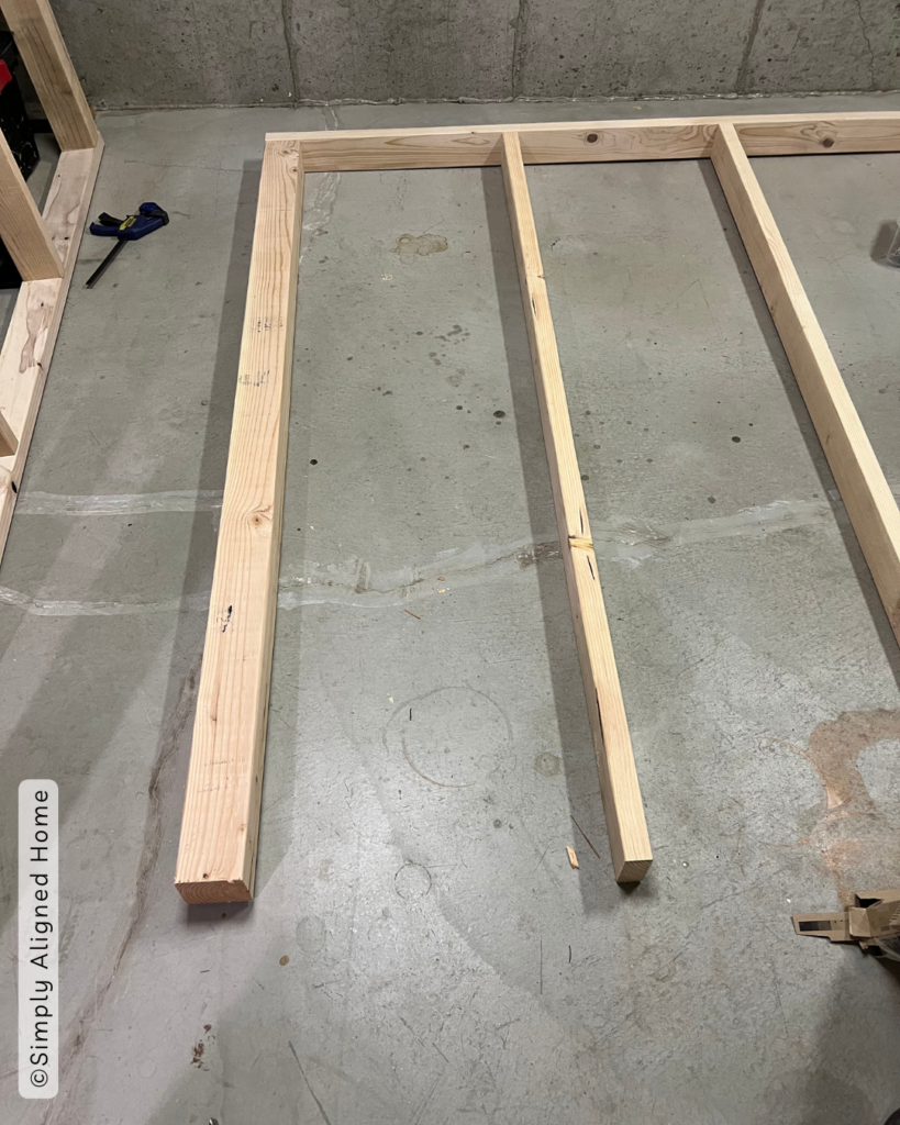 Assembling the first vertical frame of the tote storage rack. 