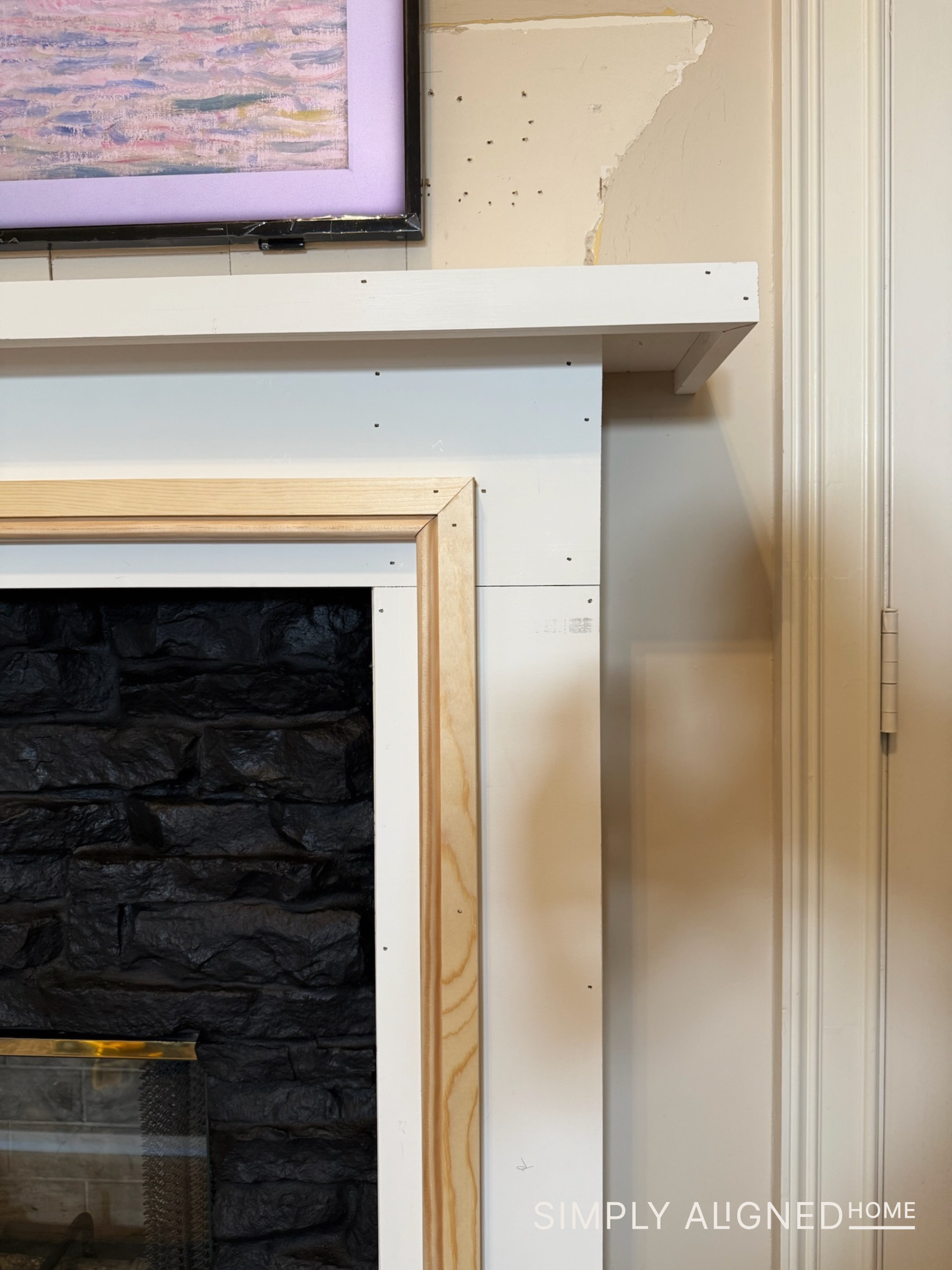 How to Update a Fireplace Surround with Wood and Trim - Simply Aligned Home